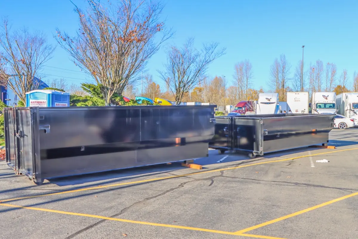 Professional dumpster rental service with roll-off container on residential driveway in Lynden